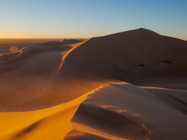 Watch sunset over the sand dunes