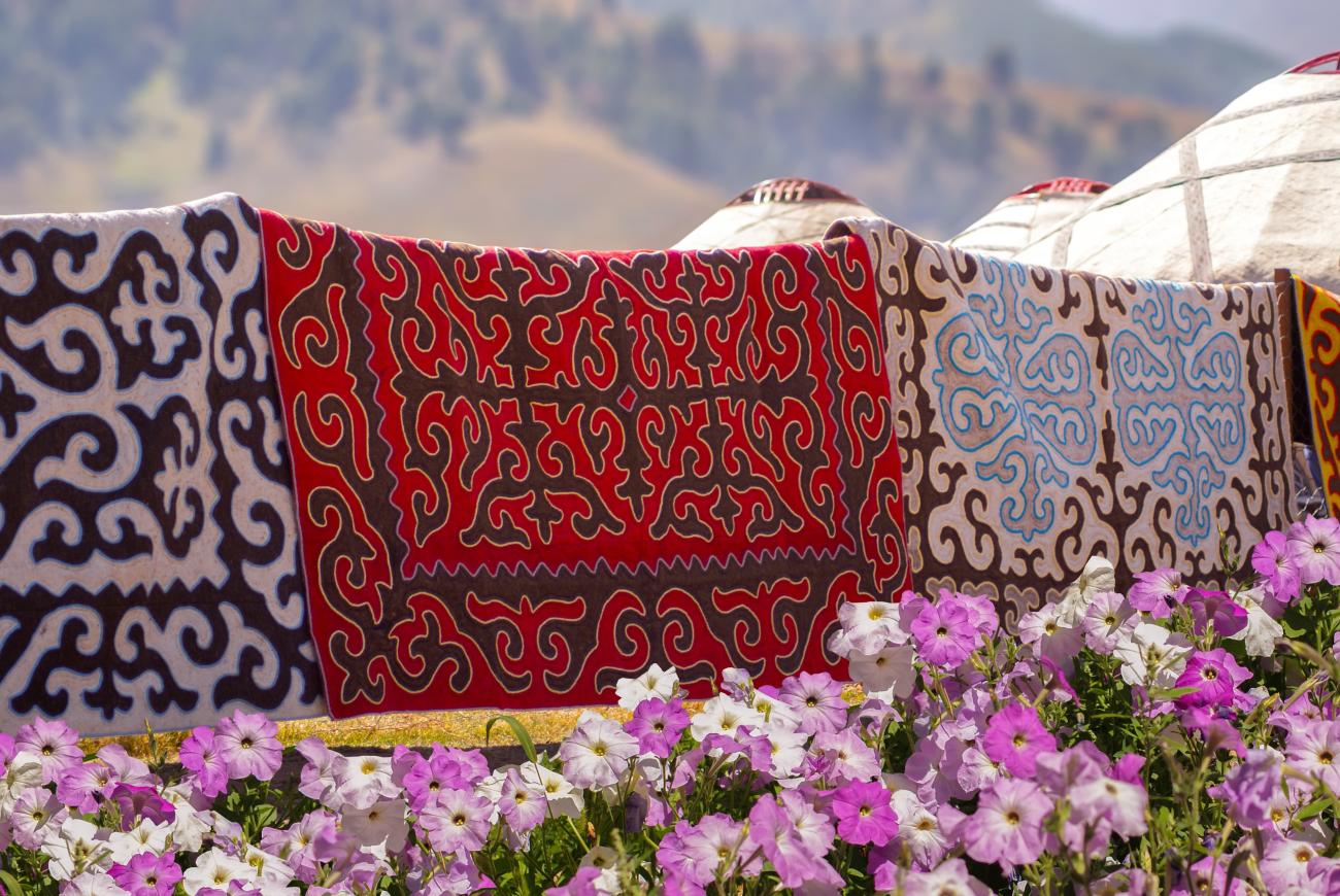 Traditional Kyrgyz rugs hanging to dry in a valley