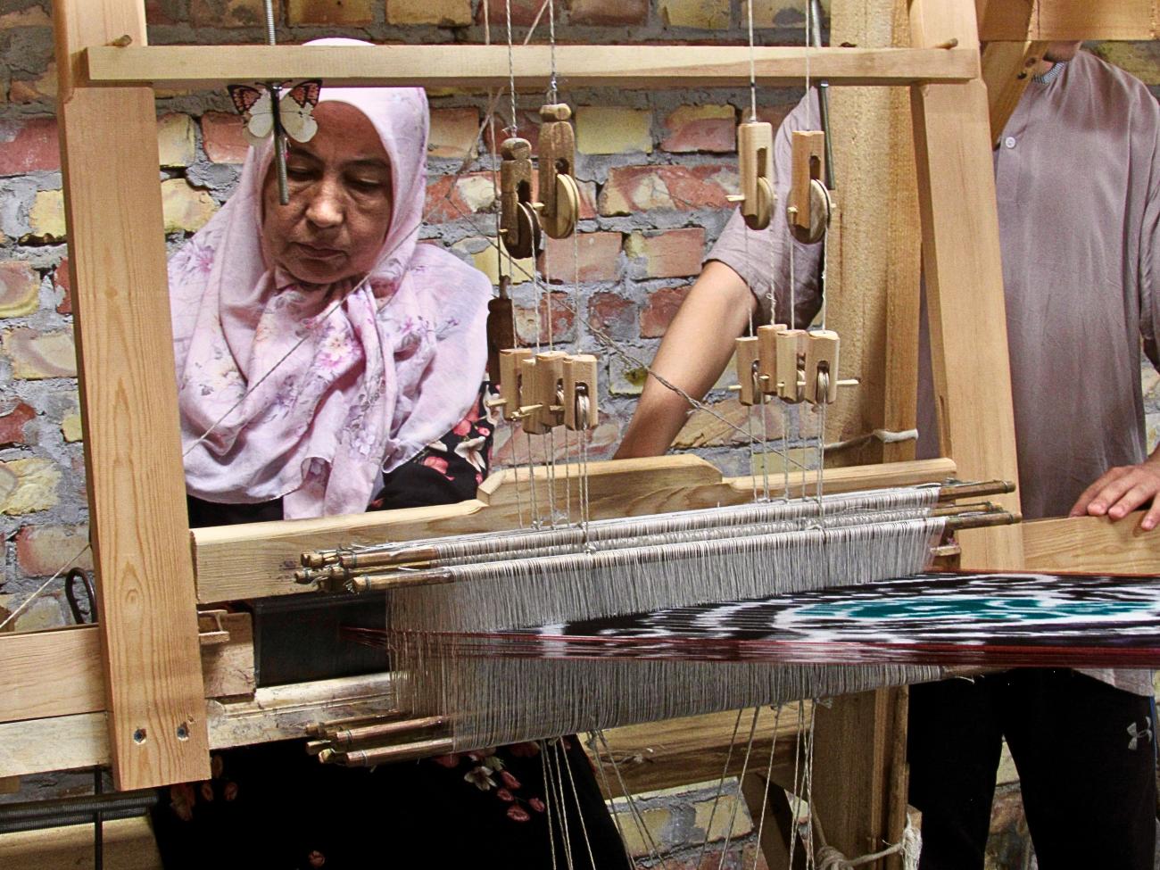 Uzbek woman weaving silk