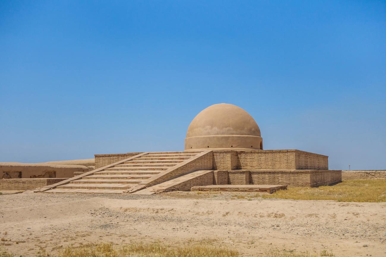 Buddhist stuppa with a protective dome covering it in Uzbekistan, with blue sky background 