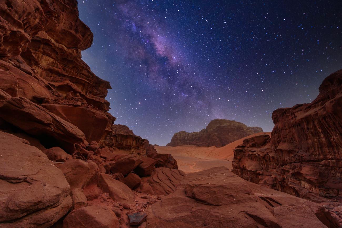 Wadi Rum desert in Jordan, rock formations and the Milky Way in the sky