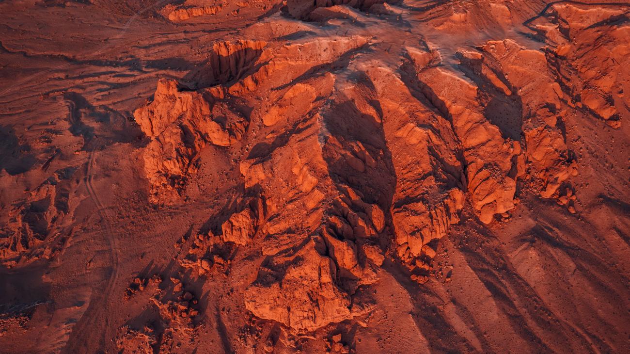 Flaming Cliffs of Mongolia, red rock formations in Gobi Desert during sunset