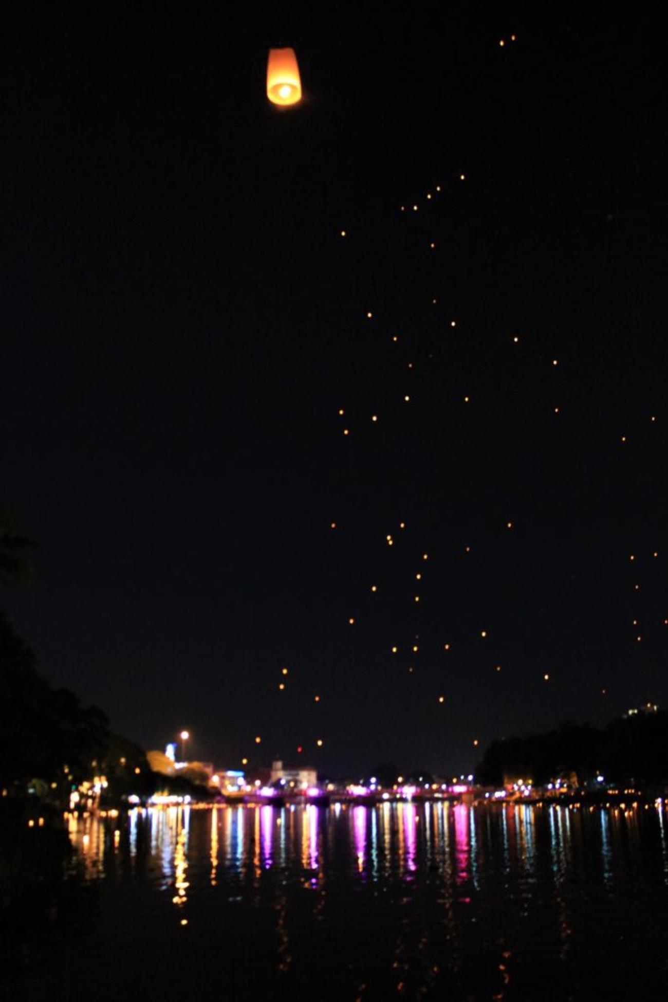 Inside the city of Chiang Mai, lanterns are released one or two at a time